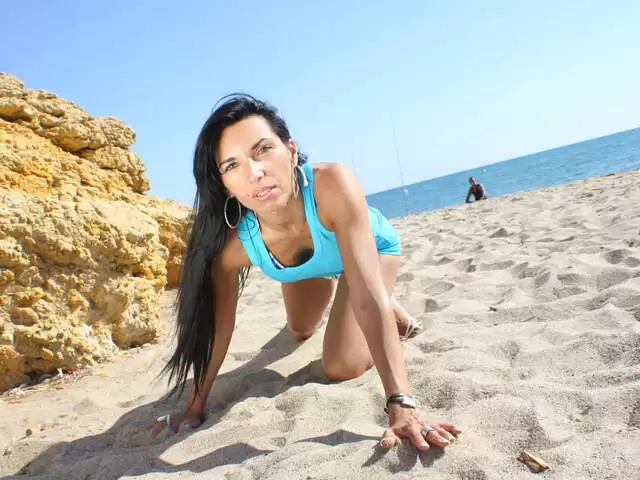 Hot mature arab brunette Bettina Kox dancing and stripping in the rocks  photo 1