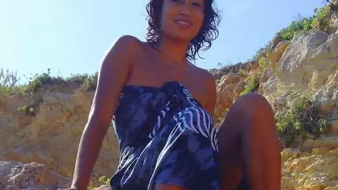 Young asian geting nude by the beach