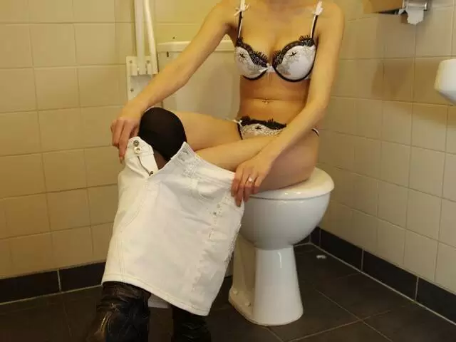 Young brunette stripping in the public toilets photo 2