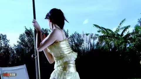 Die wunderschöne kleine Brünette Lilou Sou macht einen Striptease vor dem Pool photo 03