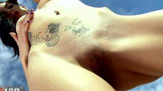 Brunette playing by the beach